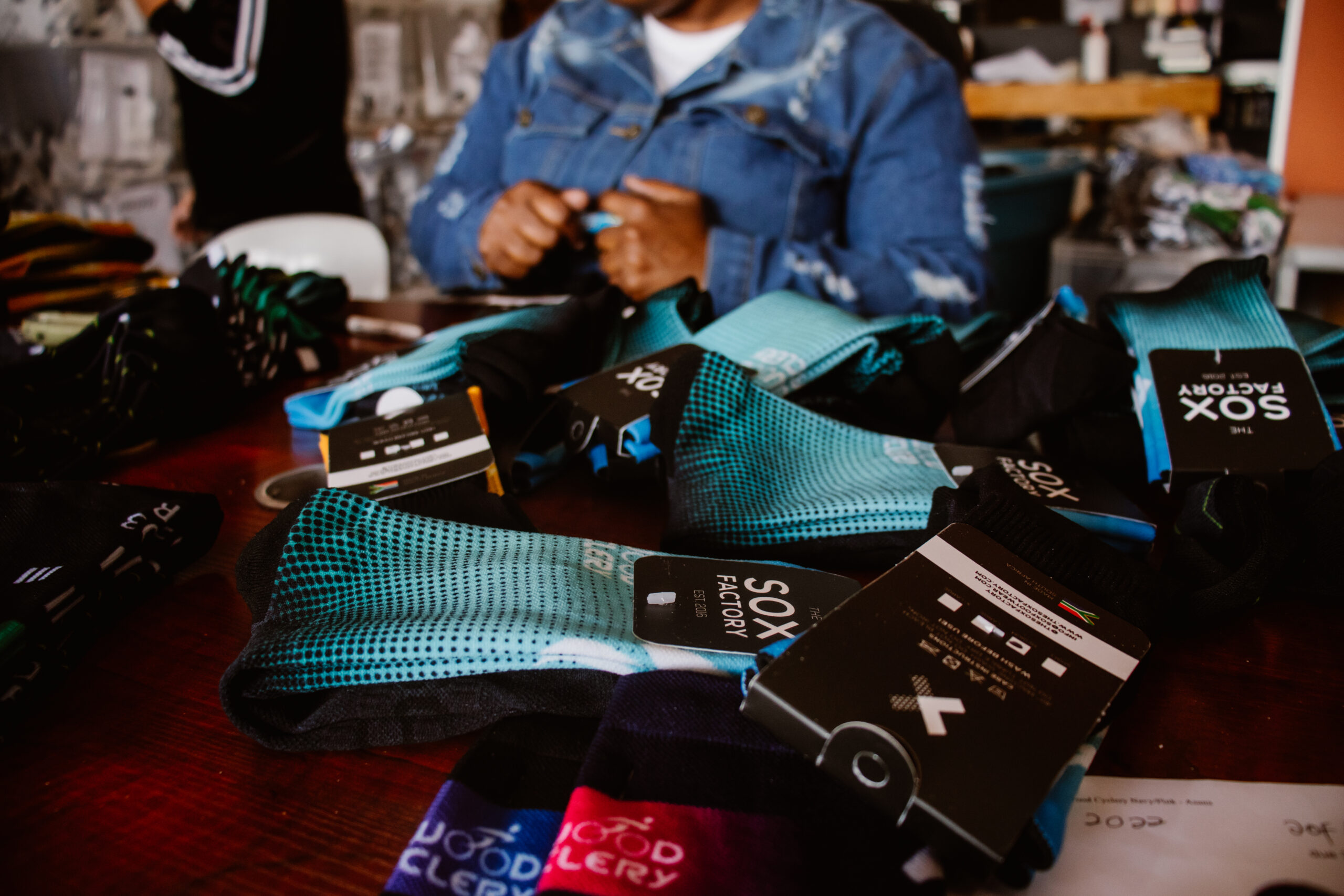 Finished Custom Socks and Brand Growth A heap of finished and tagged custom socks, symbolizing the growth and production success of The Sox Factory from 2016 to 2024.